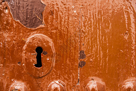 旧门上的钥匙孔 纹理有趣 是旧入口安全装置的残余锁孔古董房子安全圆柱腐蚀出口金属隐私警卫图片