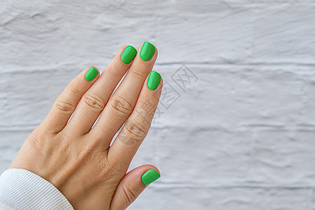 修剪整齐的女性手与时尚的绿色指甲 时尚的现代设计美甲 凝胶指甲 皮肤护理 美容治疗 指甲保养 流行色手指指甲油化妆品女士抛光温泉图片