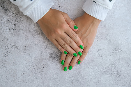 修剪整齐的女性手与时尚的绿色指甲 时尚的现代设计美甲 凝胶指甲 皮肤护理 美容治疗 指甲保养 流行色温泉沙龙指甲油女士抛光化妆品图片