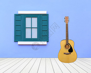 吉他 水泥墙上有窗户的吉他图片
