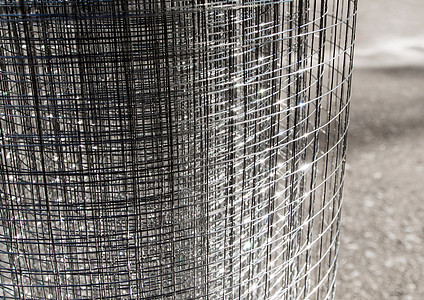 光闪闪发光的薄线板灰色网格工业安全建造栅栏金属背景图片