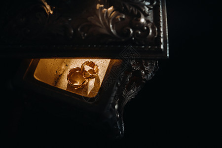 金婚戒指躺在一个古董首饰盒上 结婚戒指用于仪式夫妻庆典婚姻新娘浪漫订婚金属联盟装饰珠宝盒图片