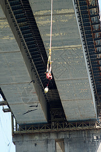 一个人从一个有弹性带的公路桥上跳下来图片