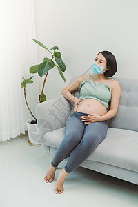 Corona病毒传播预防 保健女士女性怀孕感染母性母亲婴儿面具肚子妈妈背景图片