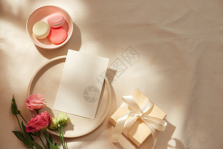 白纸条 Kraft信封 礼品盒 织物和光背景花朵的顶端视图丝带白色早餐展示杯子母亲卡片盒子粉色生日图片