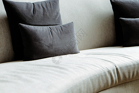 北欧风家居现代客厅沙发上的垫子亚麻棉布织物软垫灰色枕头摄影房子家具装饰背景