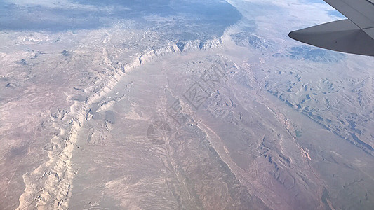 美国西部波浪纹理的飞机翼窗口视窗视图美国西部旅游假期空气航班航空地球喷射顶峰旅行技术图片