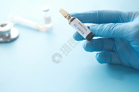 装有玻璃薄膜疫苗的乳胶手套 带有复制空间死亡瓶子医生测试安瓿流感传染性危险液体蓝色图片