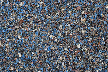 高分辨率下砾石地面纹理上蓝色鹅卵石和石头的特写视图黑色棕色白色食物灰色大理石雇用花岗岩材料岩石图片