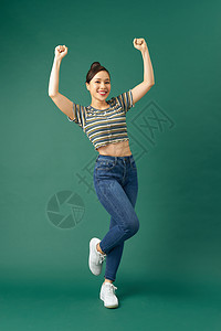 欢快的青春快乐 喜悦的女孩愚弄和跳上绿色工作室背景图片