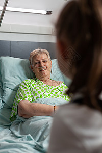 生病的退休老奶奶在睡觉时与孙女交谈女士外科访问临床孙子保健病人药品游客考试图片