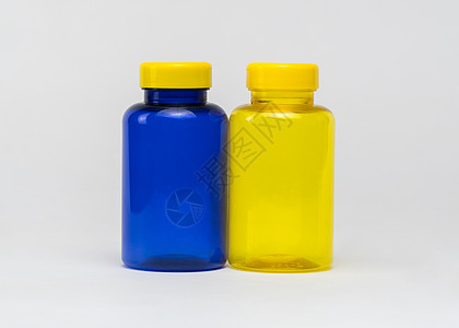塑料药瓶蓝色药片胶囊黄色制药空白药品医疗卫生包装背景图片