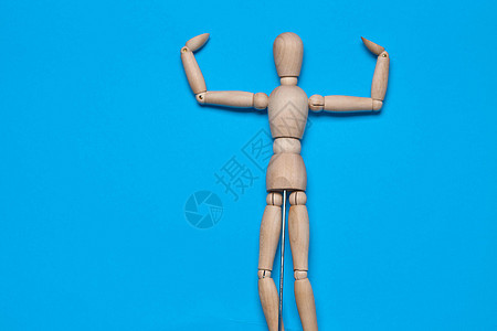 蓝色背景的木形木图造假器物体玩具人体姿势数字男性木偶冒充身体行动商业图片