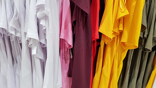 彩虹的颜色 商店衣架上的各种休闲衬衫 T 恤 各种鲜艳颜色的布棉特写 纺织背景白色绿色架子店铺衣服织物零售纺织品红色收藏背景图片