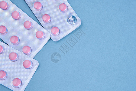 粉色药丸包装维生素止痛药蓝色背景药品制药抗生素宏观治愈疼痛白色处方帮助医疗图片