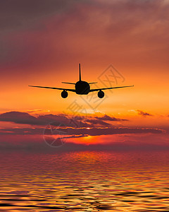 飞机飞越海面运输旅游日出客机安全旅行喷射速度喷气商业图片