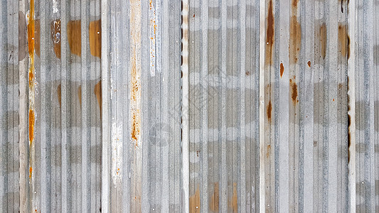 一种生锈和风化的腐蚀金属 混杂的镀锌铁板 旧的锌壁背景图片