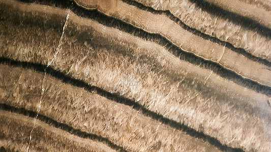 砂岩表面有波浪状的棕色纹理 硫化玛瑙质地 棕色天然石材纹理闪锌矿的宽图像 石材特写切割的美丽波浪图案建筑学石头石英矿物学宝石标本图片
