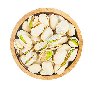 木碗里有贝壳坚果的活塞片 在白色背景中被孤立团体树叶营养宏观开心果小吃水果核心种子盐渍图片
