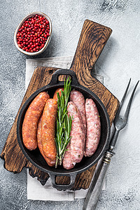 香肠 Chorizo和Bratwurst 配有香料的罗根香肠组装在一个带迷迭香的锅里 白色背景 顶端视图草本植物酒吧烹饪羊肉木板图片