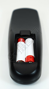 有在红色和白色的AAA碱性电池的黑电视遥控在白色背景 电池更换 备件 遥控器电池仓特写 竖拍图片