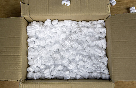 装有包装泡沫顶视图的纸板箱 木制桌上易碎产品的交货箱导游运输货运颗粒商品送货花生邮件塑料邮政图片