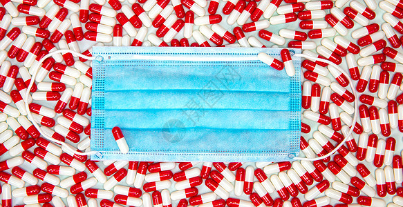 Covid19的蓝色保护面罩 带有红和白胶囊 用于治疗冠状病毒 顶视背景 健康 Covid 企业设备疫苗工具口罩药店药物卫生医疗图片