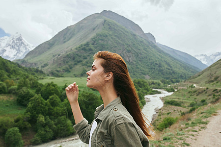 旅游山区妇女旅游山地旅行自然景观度假远足者天空顶峰地平线爬坡悬崖自由女孩背包日落图片