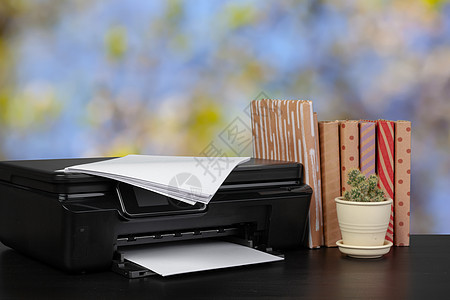 架在桌上的压缩家庭打印机 书面模糊背景的书籍扫描激光技术工作复印件桌面黑色墨水商业文书图片