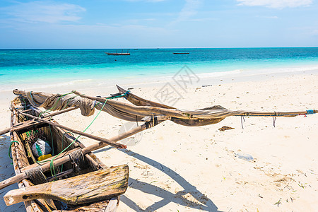 非洲海岸上的木制独木小木舟海岸线闲暇假期海洋旅游地平线太阳风景钓鱼海景图片
