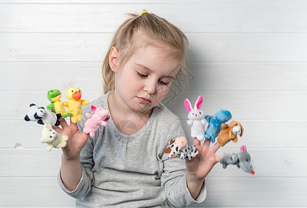 她手上拿着娃娃木偶的女孩运动闲暇幸福艺术娱乐童话孩子们驯鹿玩具乐趣图片