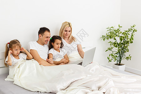 年轻家庭一起在父母的床上休息夫妻母亲睡眠感情女性男生姐姐生活父亲妈妈图片