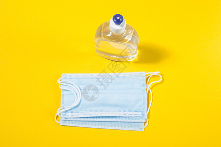 酒精凝胶手洗涤剂和一次性卫生面具瓶子黄色消毒液体感染凝胶消毒剂预防洗手液安全图片