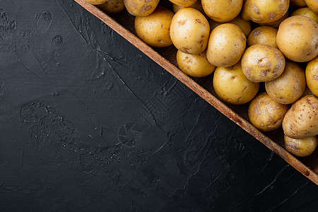 从印地亚 木箱 黑石背景 顶端视野平板铺设 复制空间和文字空间中取自India的小马铃薯小圆土豆图片