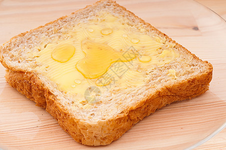 面包奶油和蜂蜜粮食小吃黄油盘子厨房早餐营养蛋糕活力小麦图片