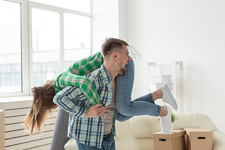 搬家期间在新公寓里玩得开心的一对疯狂的年轻夫妇 在搬家和新住房贷款的概念中 这种观念是图片