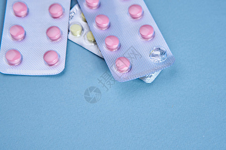 粉色药丸包装维生素止痛药蓝色背景制药抗生素药店药剂帮助疼痛红色化学品药物医院图片