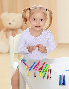 女孩用标记画画绘画白色婴儿床单微笑孩子童年学校铅笔乐趣图片