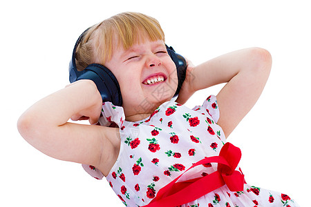 迷人的小女孩喜欢听音乐 通过耳机 笑声快乐头发孩子乐趣童年技术女性幸福娱乐微笑图片