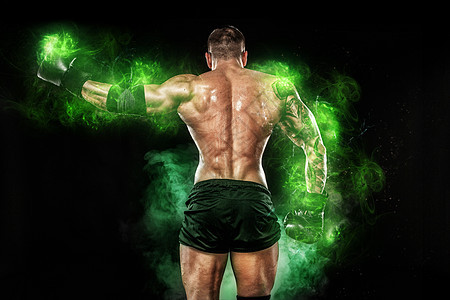 绿色能源灯下的运动员 黑背景的拳击手 运动男子 健身肌肉人 体育概念 (笑声)图片