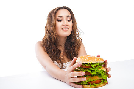 快乐的年轻妇女吃大美味汉堡与世隔绝饮食牛肉午餐成人小吃女孩包子芝麻食物脂肪图片