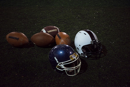 美国足球和头盔帽子地面运动体育场娱乐猪皮皮革安全运动员齿轮图片