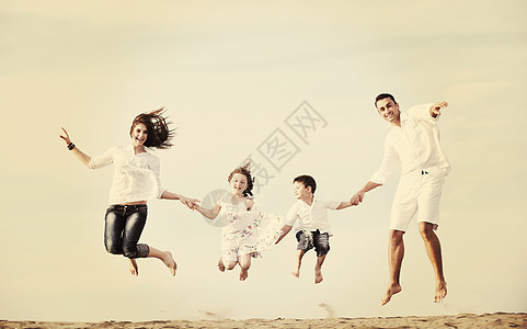 快乐的年轻家庭在海滩上玩得开心喜悦后代爸爸父亲孩子天空跑步闲暇男人假期图片