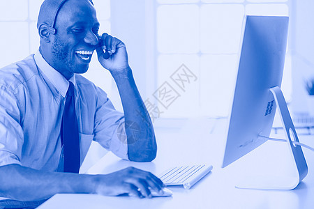 在笔记本电脑上工作的戴耳机的非裔美国商务人士专注文书男性商务经理沉思技术审查血统互联网图片