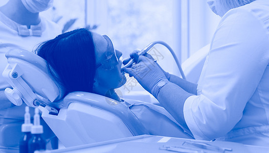 在办公室工作的年轻女牙医蓝色药品病人访问外科眼镜矫正牙齿从业者卫生图片