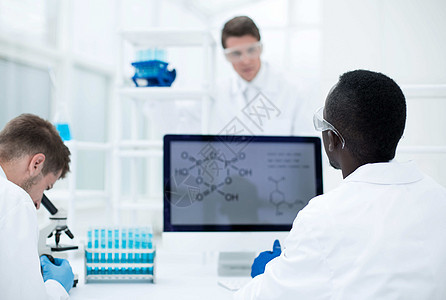在实验室中工作的科学家小组 研究组电脑药剂师男人医生监视器同事药品监控团队蓝图图片