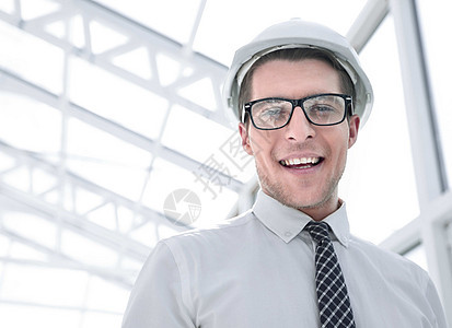 年轻建筑设计师的背景 一个明亮的办公室承包商安全头盔男性职业人士男人商务工作建筑图片