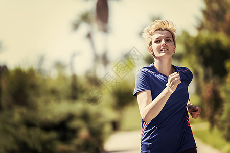 参加马拉松比赛的年轻女青年选手培训赛跑者运动员热带踪迹森林棕榈慢跑者训练跑步女士图片