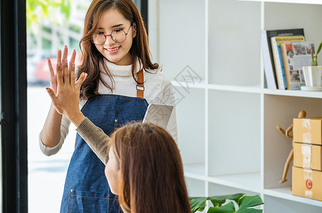 在线向企业主销售产品 专注于一位穿白衣的女士的脸 她对在线销售额超出预期的朋友表示高兴手机购物商务店铺人士企业家电子商务船运命令图片