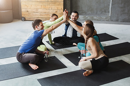 男女青年团结一心 携手合作运动帮助瑜伽工作室团队健身房会议训练女孩圆圈图片